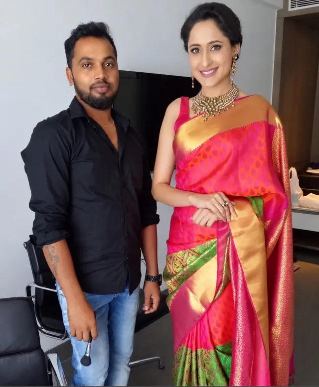 Man and woman in a colourful pink saree posing together