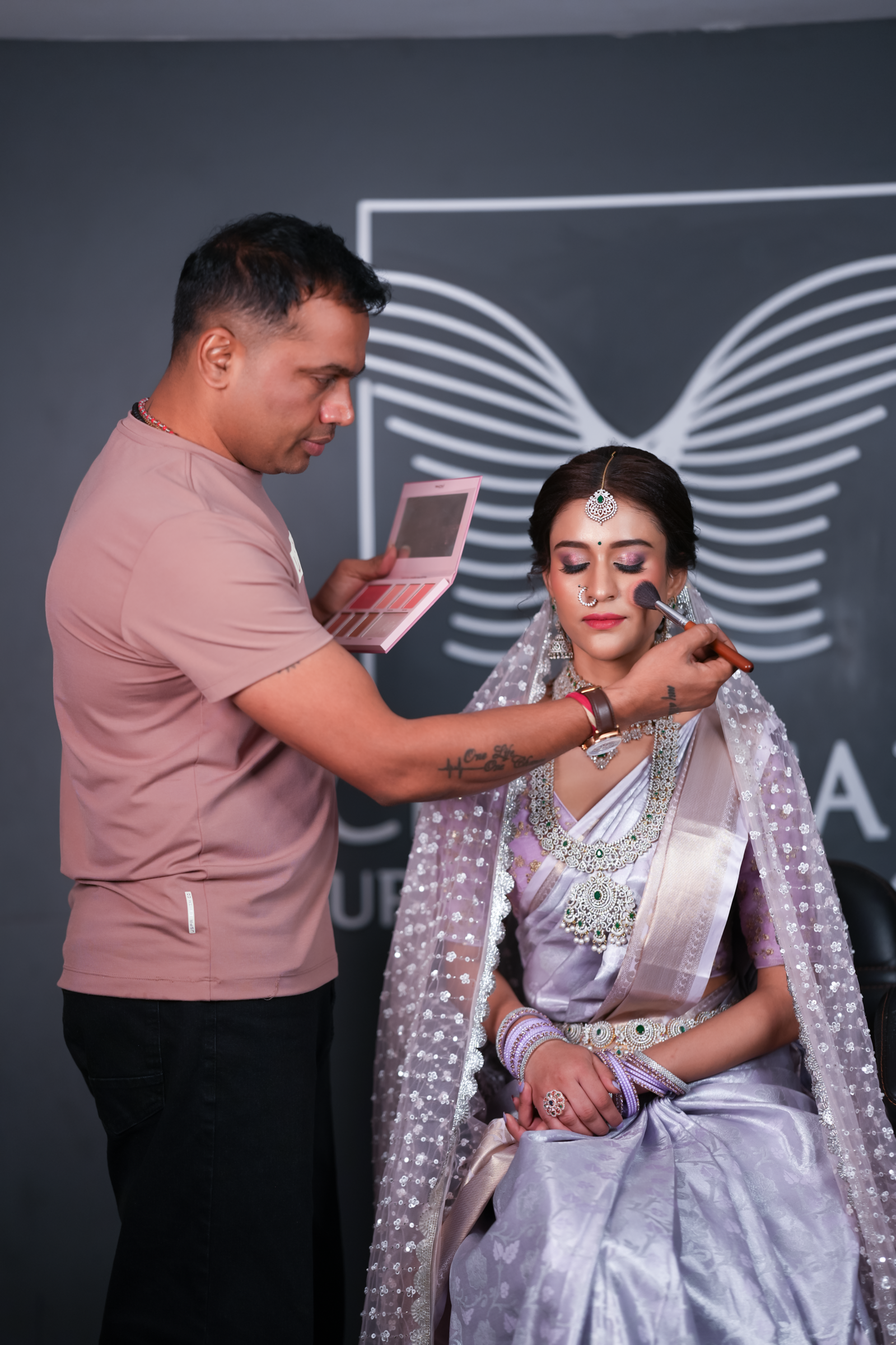 G.V. Babu demonstrating professional makeup application at Cheritan